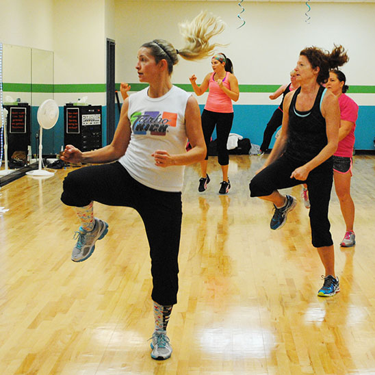 A group of people in a fitness studio during a workout.